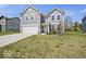 Charming two-story home with gray siding, a two-car garage, and a well-maintained lawn at 10524 Broadford St, Indianapolis, IN 46239