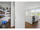 Walk-in pantry fully stocked, next to the kitchen island with a white countertop and sink and faucet at 10524 Broadford St, Indianapolis, IN 46239