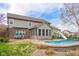 A spacious backyard includes a pool with a slide, sunroom, brick patio and room for activities at 1121 Retford Ct, Greenwood, IN 46143
