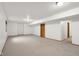 Unfinished basement with neutral carpet and white walls offers a blank canvas ready for personalization at 1121 Retford Ct, Greenwood, IN 46143