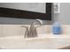 Close up on bathroom sink with neutral countertop, chrome faucet, and black framed mirror at 1121 Retford Ct, Greenwood, IN 46143