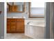 Bathroom features a double sink vanity, bathtub, and window for natural light and ventilation at 1121 Retford Ct, Greenwood, IN 46143