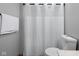 A clean bathroom with a shower featuring a white shower curtain and a toilet at 1121 Retford Ct, Greenwood, IN 46143