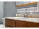 Bathroom vanity with a sink, faucet, decorative sign, and marble countertops at 1121 Retford Ct, Greenwood, IN 46143