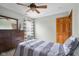 This bedroom features a ceiling fan, dresser, and a window with striped curtains at 1121 Retford Ct, Greenwood, IN 46143