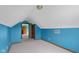 Attic bedroom with neutral carpet, teal walls, and view of a doorway to another room at 1121 Retford Ct, Greenwood, IN 46143
