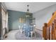 Bright dining area with round table and four chairs, illuminated by a stylish chandelier at 1121 Retford Ct, Greenwood, IN 46143