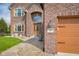 Charming brick home featuring a well-manicured lawn and close-up view of house number at 1121 Retford Ct, Greenwood, IN 46143