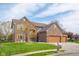 Charming brick home with a three-car garage, well-manicured lawn and mature trees at 1121 Retford Ct, Greenwood, IN 46143