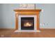 Close up on cozy fireplace with wooden mantel, tile surround, and a warm, inviting ambiance at 1121 Retford Ct, Greenwood, IN 46143