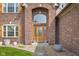 Inviting home entrance with arched entryway, glass door, and landscaped surroundings at 1121 Retford Ct, Greenwood, IN 46143