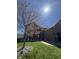 Two-story brick home with a manicured lawn, walkway, attached garage, and blossoming tree under a sunny sky at 1121 Retford Ct, Greenwood, IN 46143