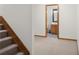 Carpeted hallway leads to a half bath with black and white mosaic tile flooring at 1121 Retford Ct, Greenwood, IN 46143