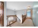 Upstairs hallway featuring carpet, stairs and access to multiple rooms at 1121 Retford Ct, Greenwood, IN 46143