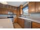 This kitchen boasts stainless steel appliances, wooden cabinets, and ample counter space at 1121 Retford Ct, Greenwood, IN 46143