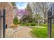 Landscaped walkway features lush greenery, flowering trees, and decorative stones at 1121 Retford Ct, Greenwood, IN 46143