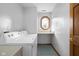 Well-lit laundry room with washer, dryer, utility sink, and octagon window at 1121 Retford Ct, Greenwood, IN 46143