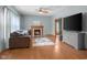 Warm living room featuring fireplace, hardwood floors, and large TV and cabinet at 1121 Retford Ct, Greenwood, IN 46143