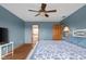 Spacious main bedroom featuring a ceiling fan, wood floors, and an ensuite bathroom at 1121 Retford Ct, Greenwood, IN 46143
