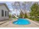 Inviting backyard pool with slide and surrounding patio offers a private oasis for relaxation and fun at 1121 Retford Ct, Greenwood, IN 46143