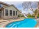 Backyard pool features a slide, concrete surround, and a sunroom addition on this suburban home at 1121 Retford Ct, Greenwood, IN 46143
