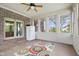 Bright sunroom with exposed brick, ceiling fan, and multiple windows, perfect for relaxation at 1121 Retford Ct, Greenwood, IN 46143