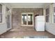 Bright sunroom with exposed brick, ceiling fan, and multiple windows, perfect for relaxation at 1121 Retford Ct, Greenwood, IN 46143