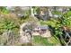 An aerial perspective of a house nestled among trees with a large yard and a driveway at 11625 Rolling Springs Dr, Carmel, IN 46033