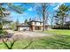 The backyard displays ample parking space and a partially renovated home at 11625 Rolling Springs Dr, Carmel, IN 46033