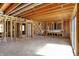 Unfinished basement with exposed beams, stairs, and concrete floors at 11625 Rolling Springs Dr, Carmel, IN 46033