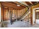 Partially finished basement with exposed wood beams, framing, and stairway at 11625 Rolling Springs Dr, Carmel, IN 46033