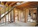 Partially finished basement with stairs, exposed wood beams, and concrete floors at 11625 Rolling Springs Dr, Carmel, IN 46033