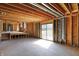 Partially finished basement with exposed wood beams, sliding door and concrete floors at 11625 Rolling Springs Dr, Carmel, IN 46033