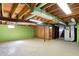 Open basement area with exposed wood ceiling, storage space and stairs for an adaptable living space at 11625 Rolling Springs Dr, Carmel, IN 46033