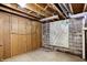 Spacious basement showcases wooden wall paneling, map and concrete block foundation, waiting for customization at 11625 Rolling Springs Dr, Carmel, IN 46033
