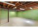 Unfinished basement with concrete floors and green painted walls providing space for storage or customization at 11625 Rolling Springs Dr, Carmel, IN 46033