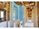 The image features a bathroom under construction and renovation, showing exposed framing and updated plumbing at 11625 Rolling Springs Dr, Carmel, IN 46033