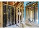 Bathroom under renovation, framed out walls, octagonal window, and a vintage vanity at 11625 Rolling Springs Dr, Carmel, IN 46033