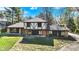 Exterior view of a two-story house with timber accents needing work on the facade at 11625 Rolling Springs Dr, Carmel, IN 46033
