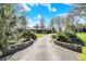Beautiful front exterior featuring a long driveway and picturesque landscaping at 11625 Rolling Springs Dr, Carmel, IN 46033