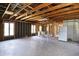 Open garage space with concrete flooring, ample windows, and exposed beams, ideal for a workshop at 11625 Rolling Springs Dr, Carmel, IN 46033