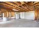 The spacious garage features concrete flooring, exposed ceiling, and a refrigerator for added convenience at 11625 Rolling Springs Dr, Carmel, IN 46033