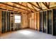 Spacious interior, with exposed beams and studs, ready for your renovation dreams to come to life at 11625 Rolling Springs Dr, Carmel, IN 46033