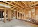 In-progress interior with exposed wood studs, presenting a renovation-ready opportunity with staircase at 11625 Rolling Springs Dr, Carmel, IN 46033