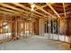 Open unfinished interior space, exposed wood framework, and large windows offering ample renovation opportunities at 11625 Rolling Springs Dr, Carmel, IN 46033