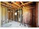 Spacious interior under renovation, featuring exposed framing and a unique octagonal window at 11625 Rolling Springs Dr, Carmel, IN 46033