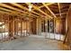 Large unfinished interior with exposed wood framework, showcasing potential for renovation and personalized design at 11625 Rolling Springs Dr, Carmel, IN 46033