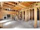 Unfinished living room featuring the exposed wooden framing, with a staircase and fireplace visible at 11625 Rolling Springs Dr, Carmel, IN 46033