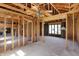Unfinished living room showcasing the exposed beams, with a fireplace visible in the background at 11625 Rolling Springs Dr, Carmel, IN 46033