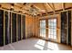 Unfinished living room showing the bare framework, a ceiling fan, and glass doors leading outside at 11625 Rolling Springs Dr, Carmel, IN 46033